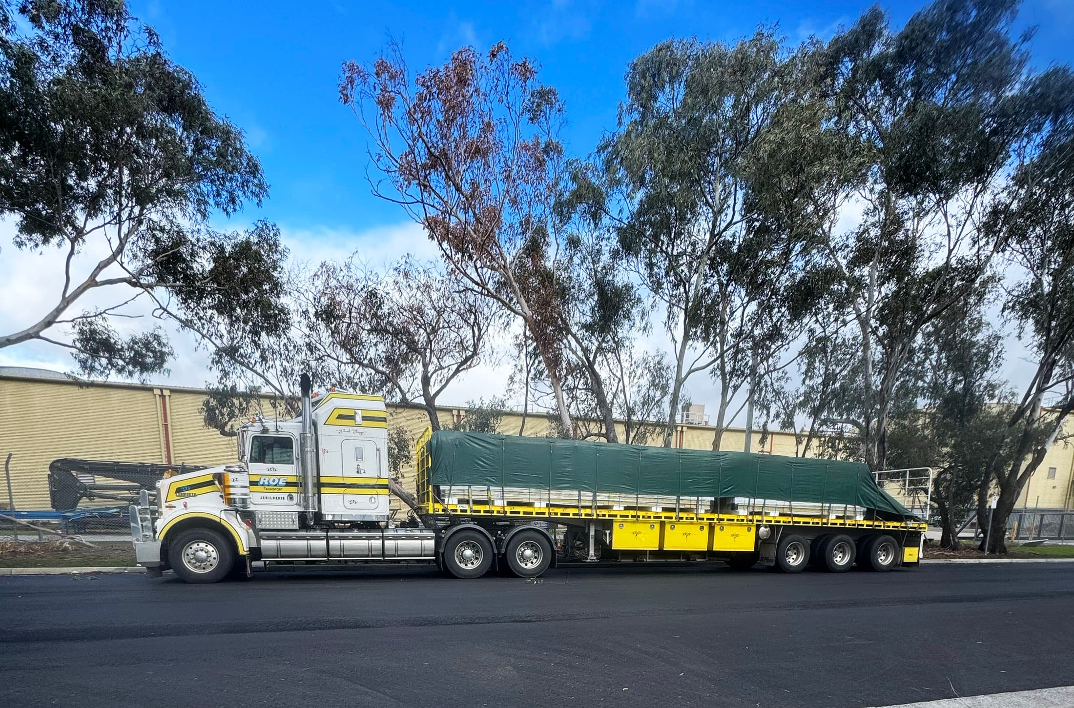 Steel beams and structural steel being transported